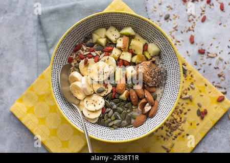 Breakfast bowl of porridge with lots of toppings Stock Photo