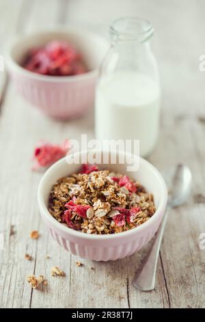 Homemade crunchy muesli with candied hibiscus flowers and grain milk Stock Photo