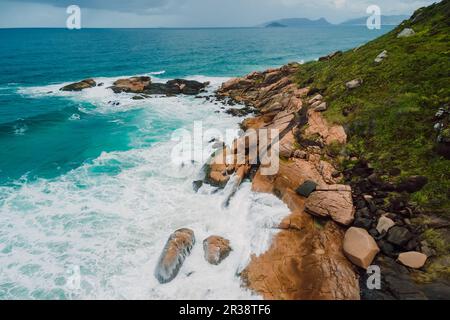 Rocky coastline and ocean with stormy waves in Brazil. Aerial view Stock Photo