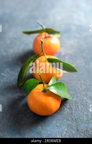 Mandarins on a stone surface, close up Stock Photo