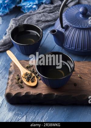 Green tea in blue cups with blue cast iron tea pot Stock Photo