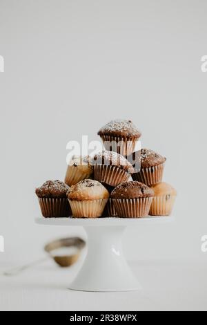 Mini muffins with chocolate drops on a cake stand Stock Photo