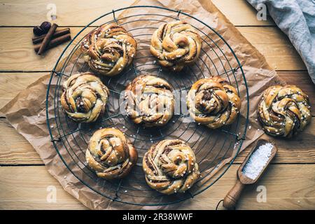 Norwegian cinnamon buns on a wire rack Stock Photo