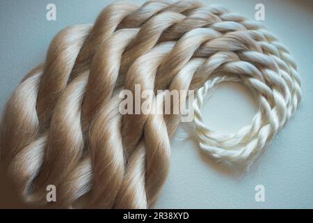 Kanekalon artificial material for weaving in African braids, equipment and materials for beauty salons, blond hair, blond hair Stock Photo