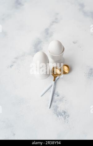 Two eggs in eggcups and spoons Stock Photo