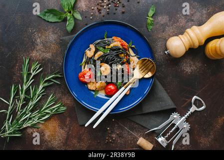 Black spaghetti with prawns in creamy sauce Stock Photo