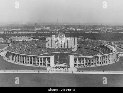 Berlin Olympics 1936. The 1936 Summer Olympics (German: Olympische Sommerspiele 1936), officially known as the Games of the XI Olympiad (German: Spiele der XI. Olympiade) and commonly known as Berlin 1936, were an international multi-sport event held from 1 to 16 August 1936 in Berlin, Germany.  Pictured Olympiastadion in Berlin a stadium built for the 1936 summer olympics with room for 100 000 people. Stock Photo