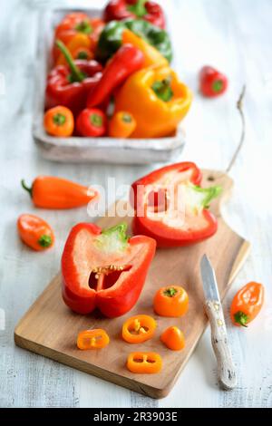 Red and yellow peppers, partly sliced Stock Photo