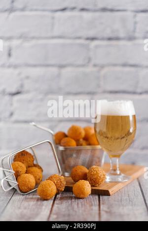 Fried cheese balls and a glass of light beer Stock Photo