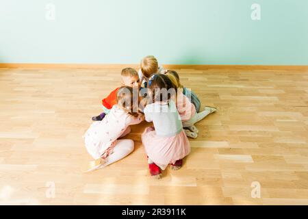 Cool kids sitting together in a small pile Stock Photo