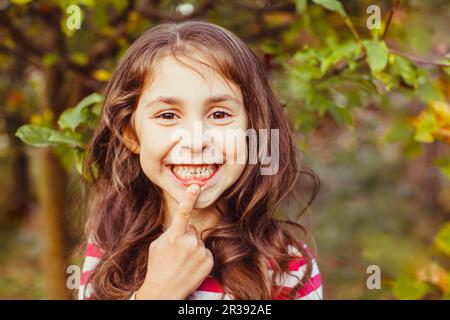 Child pointing recently erupted permanent front tooth Stock Photo