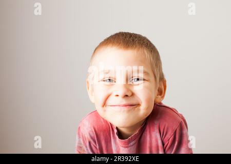 Portrait of fair-haired boy with chocolate on his face Stock Photo