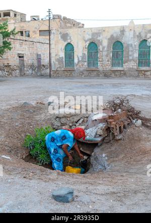 Eritrean woman collecting water in the town, Northern Red Sea, Massawa, Eritrea Stock Photo