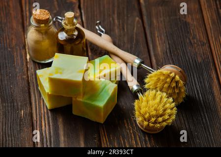 Kitchen compostable cleaning tools on wooden table Stock Photo