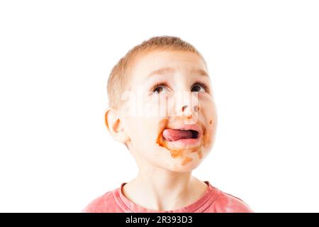 Portrait of fair-haired boy with chocolate on his face isolated on white Stock Photo