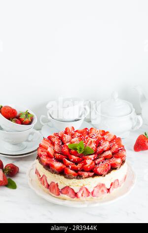 Strawberry cake Fraisier on the white plate and cups Stock Photo