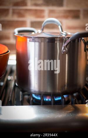 A large pot on a gas hob Stock Photo