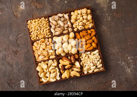 Variety of nuts in wooden box from top view Stock Photo