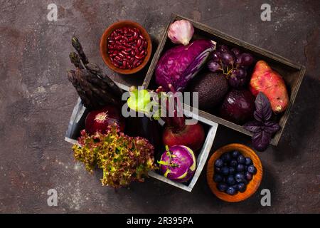 Composition of colourful berries and vegetables on the floor Stock Photo
