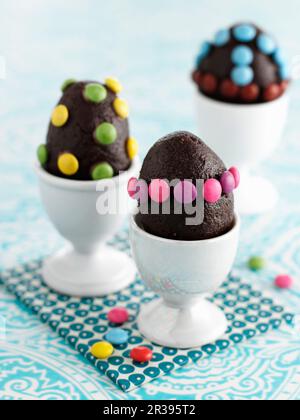 Chocolate eggs with colorful chocolate beans Stock Photo