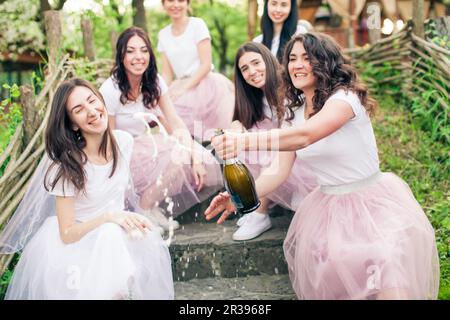 Moment of champagne bottle opening while hen party Stock Photo