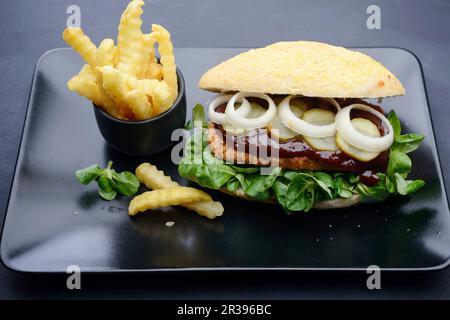 A bean steak with smoky sauce in a corn bun (vegan) Stock Photo