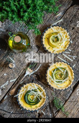 Savoury tartlets with courgette and parmesan in a baking dish Stock Photo