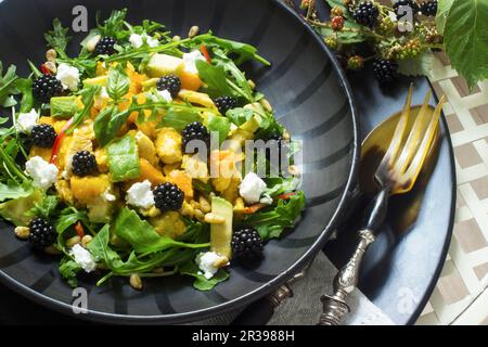 Pumpkin and avocado salad with blackberries and cream cheese Stock Photo