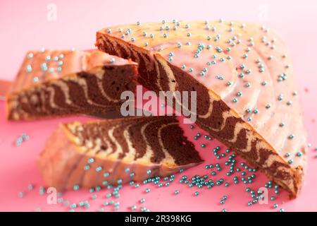 Christmas zebra cake with orange and pink icing Stock Photo