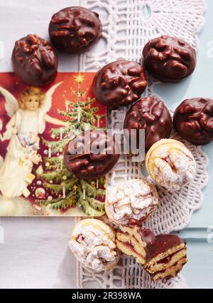 Oval walnut and raspberry biscuits with jam and chocolate glaze Stock Photo