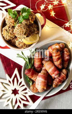 Sausages wrapped in bacon and stuffing dumplings for Christmas Stock Photo
