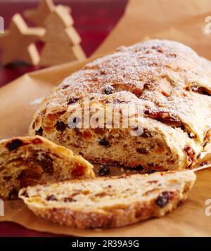 Sweet fruit and nut bread with dried fruit on baking paper Stock Photo