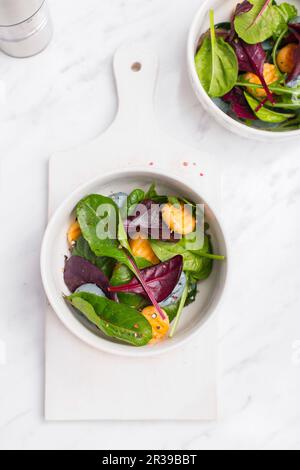 Gnocchi Salad in a white bowl on a marble table Stock Photo