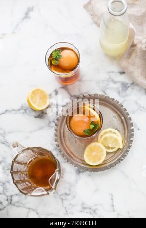 Iced tea with ice balls and lemon Stock Photo