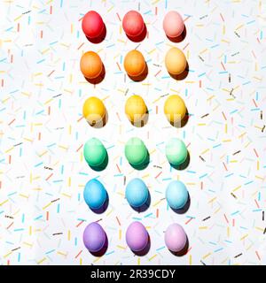 Colourful Easter eggs arranged in a colour gradient (top view) Stock Photo