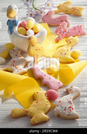 Colourful Easter biscuits with yellow ribbon and Easter eggs Stock Photo