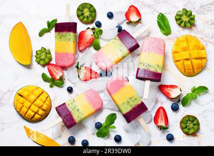 Strawberry, mango, kiwi and blueberry ice cream pops with fruits Stock Photo