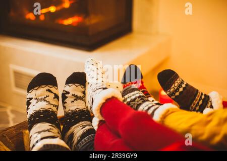 Big family is warming near the fireplace Stock Photo