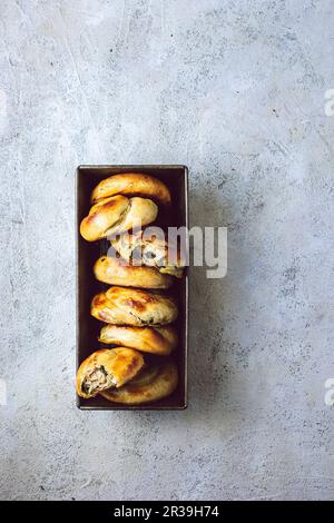 Greek handpies made of phyllo pastry, filled with feta and spinach Stock Photo