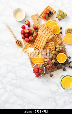 Waffles with fruits and orange juice Stock Photo