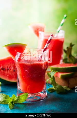 Summer refreshing watermelon drink in glasses with mint and drinking straw Stock Photo