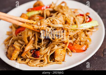 Asian vegan udon noodles with tofu and vegetables Stock Photo
