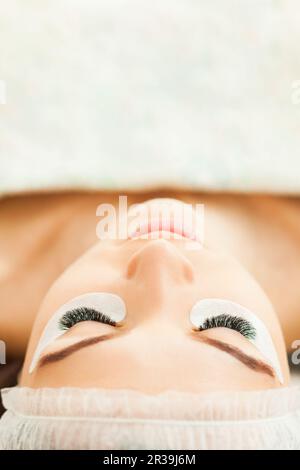 Eyelash extension procedure close up. Beauty concept Stock Photo