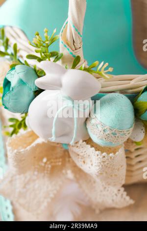 Cute ceramic Easter bunny and dyed eggs Stock Photo