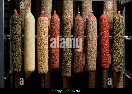 Various salamis hanging in a ripening room Stock Photo