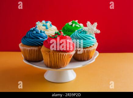 Cakestand with colorful cupcakes decorated with sparkles Stock Photo