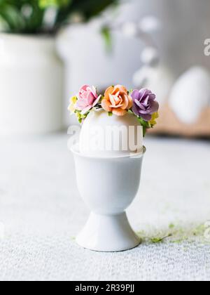 Easter egg with flower decoration in an eggcup Stock Photo