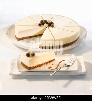 Vanilla cheesecake with a biscuit base serves fourteen Stock Photo