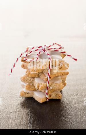 A stack of cinnamon stars tied with string Stock Photo