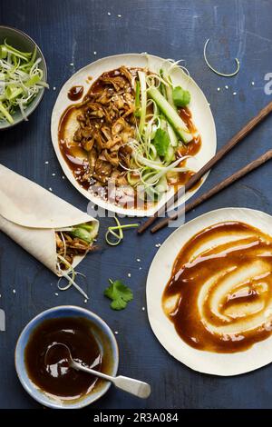 Vegan Chinese Jackfruit 'duck style' pancakes being made on a dark blue background Stock Photo